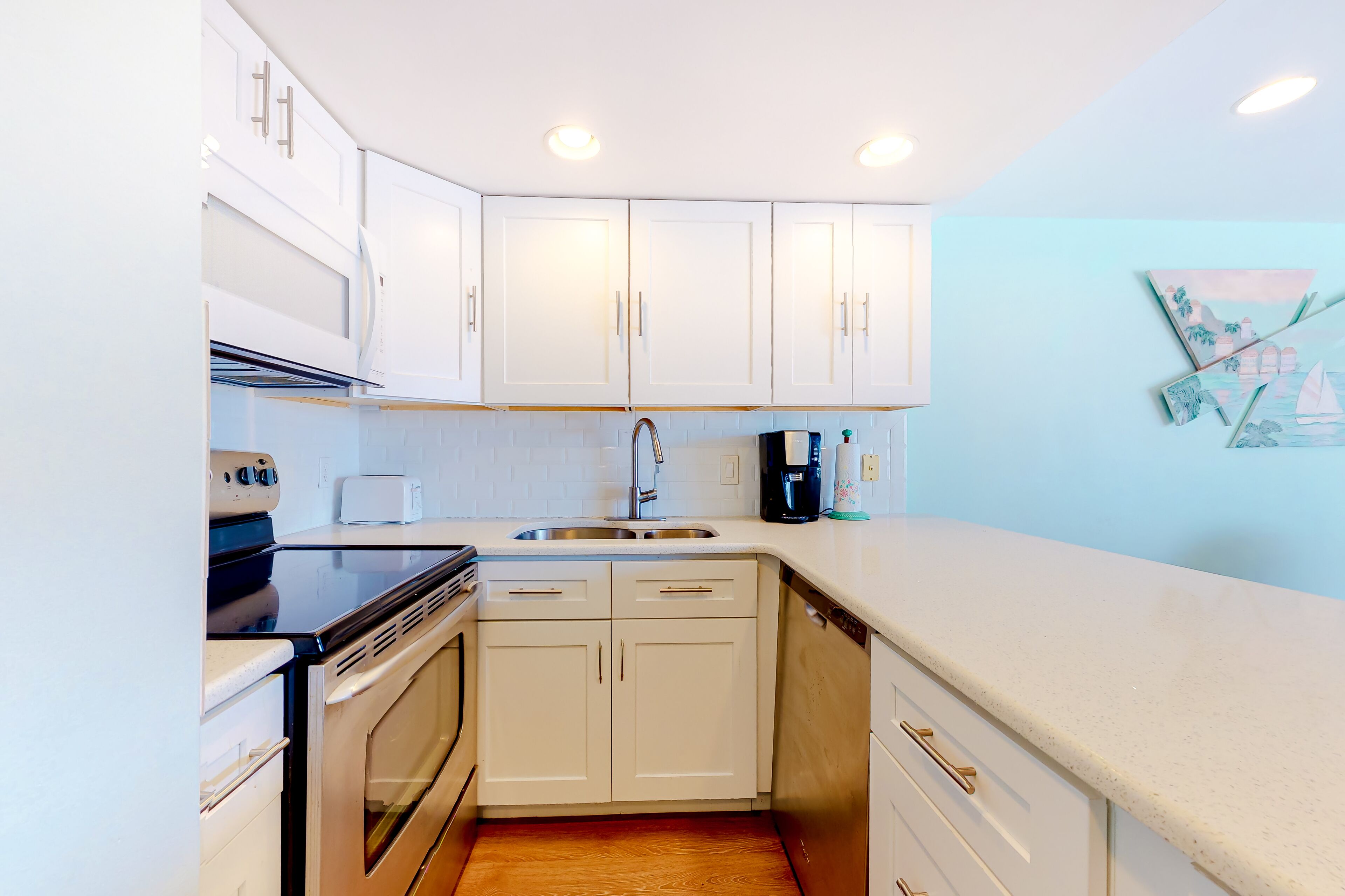 Updated, third-floor condo with balcony, W/D, central AC, & WiFi - near beach