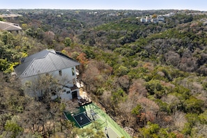 Escape to a serene retreat surrounded by a lush, wooded area and enjoy access to a tennis court.