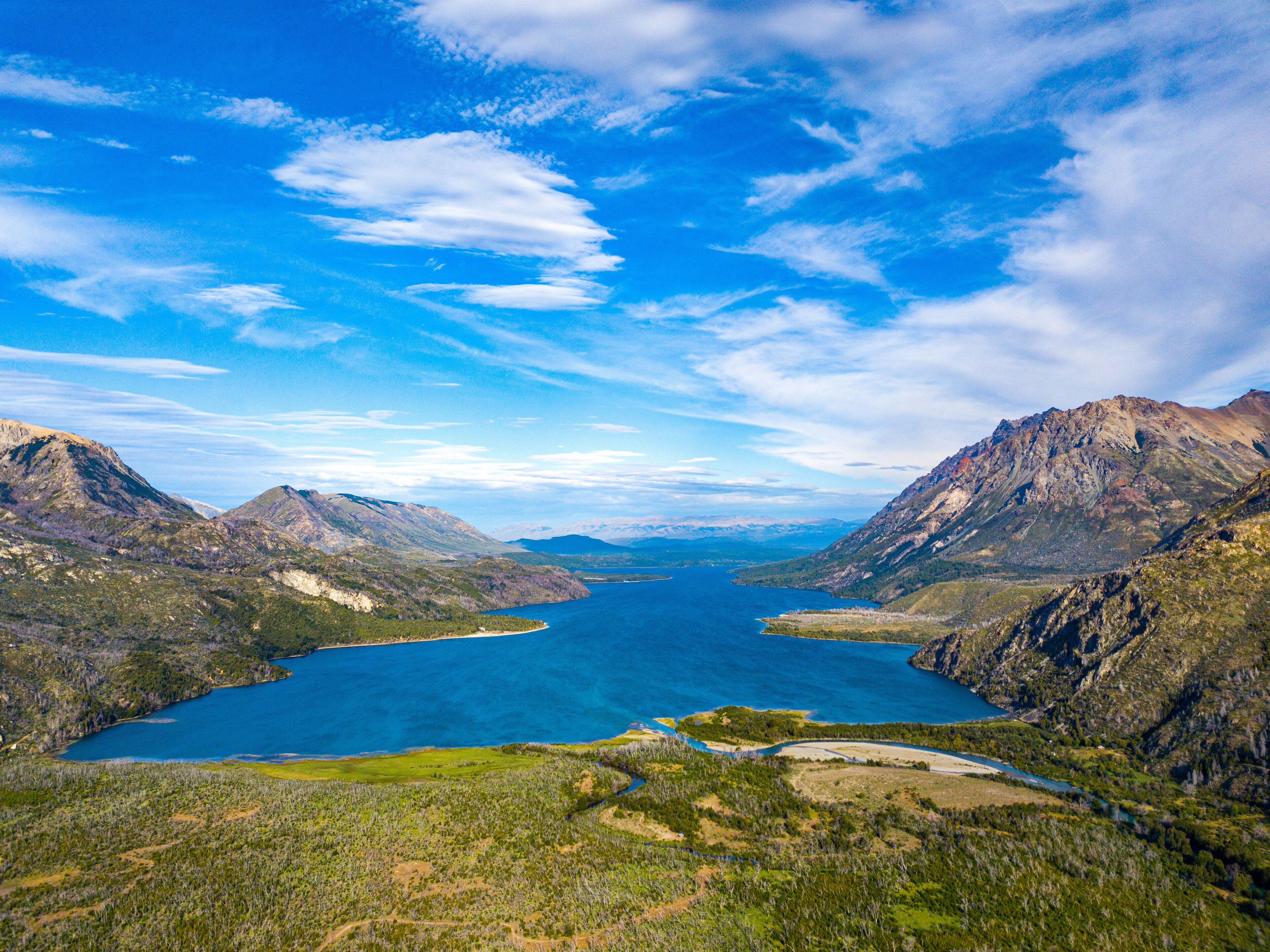 A mountainous landscape with a large lake surrounded by rugged terrain.
