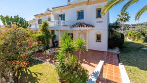A two-story house with a white facade and terracotta roof tiles. - Lovely vacation home with amazing views and private pool | Townhouse Calahonda (Mijas Costa)