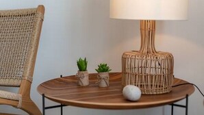 A round wooden table with a woven lamp and two small potted plants. - Mamma mia luxury rooms - Double Room with Sea View (Trogir)