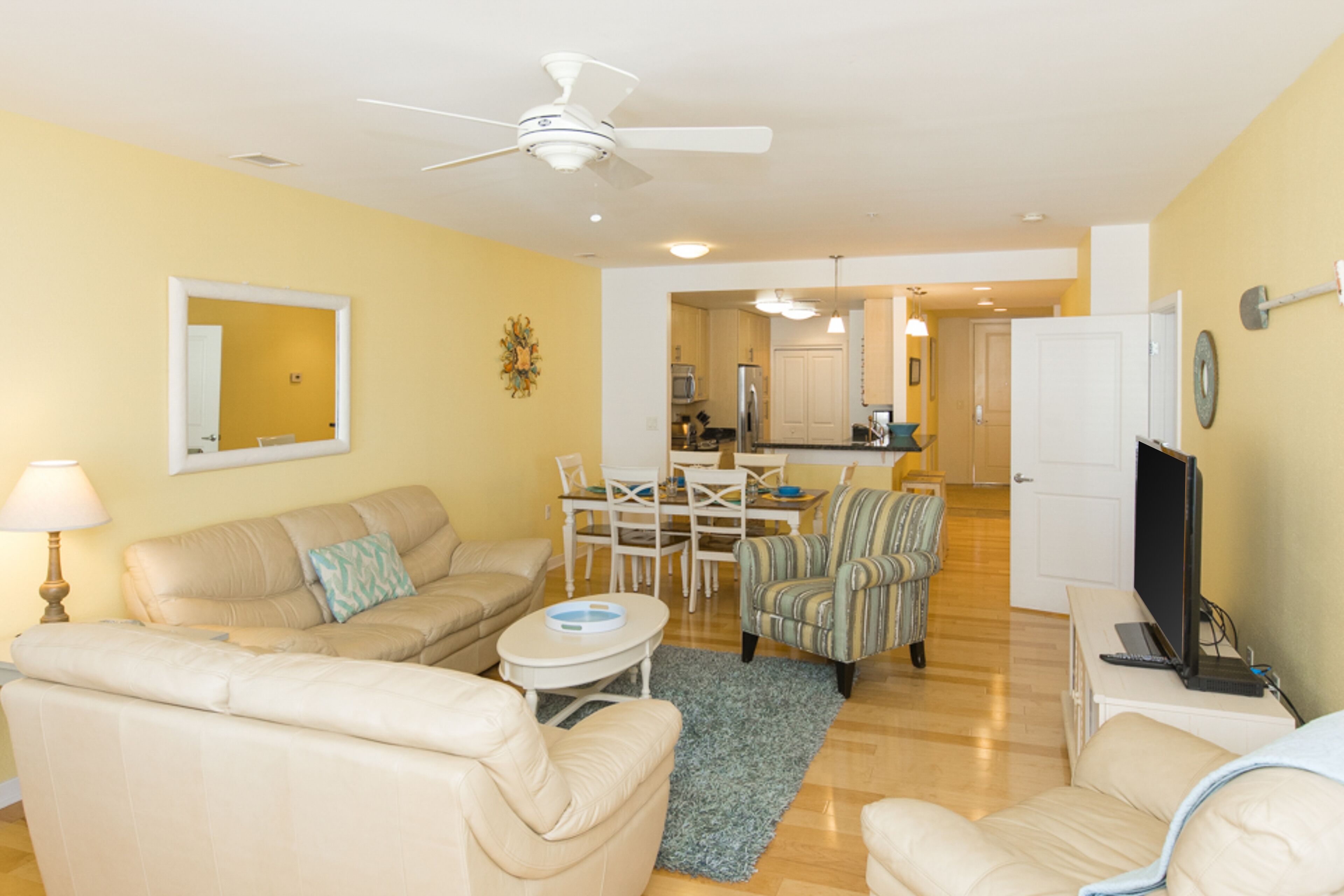 Bright 3rd-floor courtyard condo with private balcony, on-site pools, gym & AC