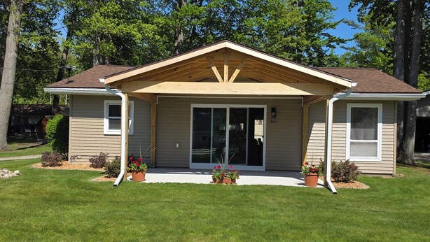 A single-story house with a front porch, a garage, and a number '316' on the wall.