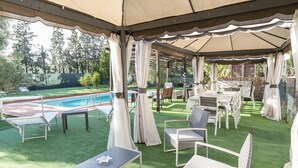 An outdoor patio with a pool, covered seating area, and a view of the pool. - VILLA ZAGARA (Tipical luxury Sicilian residence) (Sicilia)