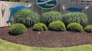A sign reading "Sea Dunes" with a pool and landscaping. - Awesome suite, 100 steps to the ocean! (Kitty Hawk)