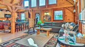 A spacious log cabin interior with a kitchen, dining area, and living room. - West Danville Cabin: Day Trip to Stowe Mtn! (West Danville)