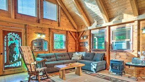 A cozy log cabin interior with a wooden ceiling, a rocking chair, a sofa, and a fireplace. - West Danville Cabin: Day Trip to Stowe Mtn! (West Danville)