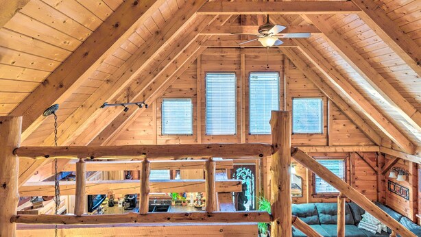 A wooden cabin with a sloped ceiling, a ceiling fan, and a view of the outdoors through windows. - West Danville Cabin: Day Trip to Stowe Mtn! (West Danville)