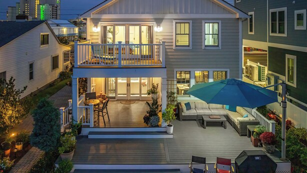 A two-story house with a balcony, outdoor seating area, and a barbecue grill. - Dock Access: Waterfront Ocean City Home Near Beach (Ocean City)