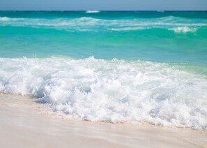 A beach with waves crashing onto the shore. - 200 steps to the Beach! 1 King bed, 1 bath. Porch swing. (Miramar Beach)