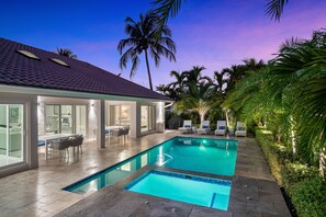 A swimming pool with a tiled deck, a covered patio with outdoor seating, and palm trees. - BY THE SEA VACATION VILLAS 5 STAR AZUL 3/2 PRIVATE POOL WALK TO BEACH (Fort Lauderdale)