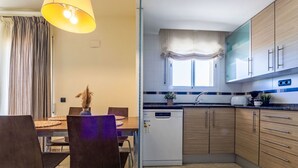 Een moderne keuken met houten kastjes, een ingebouwde vaatwasser en een eethoek met een tafel en stoelen.