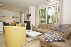 A modern living room with a sofa, yellow armchair, and a coffee table.