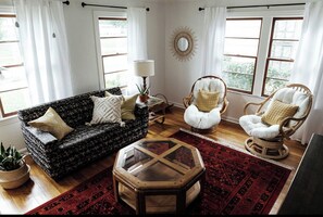 Relax in this inviting living room with a sofa, coffee table, and armchairs.