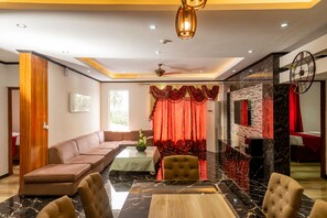 Exclusive Room, 3 Bedrooms | Living area | 36-inch LED TV with cable channels, TV