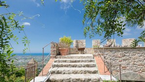 A stone staircase leading up to a terrace with a view of the sea. - Castle with pool and sea views for 6 People (Monteggiori)