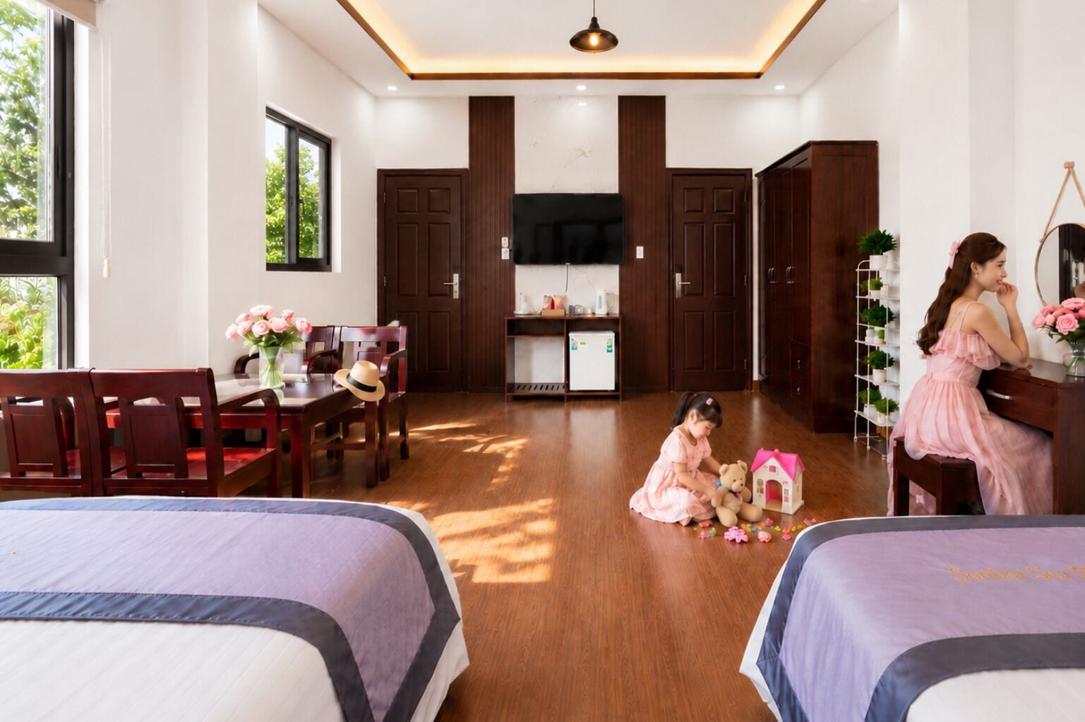 A hotel room with a dining area, a TV, wooden cabinets, and a bed.