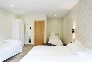 Habitación triple | Decoración personalizada, muebles diferentes y cuna de viaje