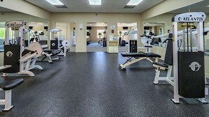 A gym with various exercise machines, benches, and mirrors. - Our Legacy - Dog Friendly Oceanside 4 BR Cottage with Community Pool access (Duck)