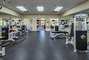 A gym with various exercise machines, benches, and mirrors. - Our Legacy - Dog Friendly Oceanside 4 BR Cottage with Community Pool access (Duck)
