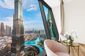 A high-rise building with a view of a cityscape and a river.