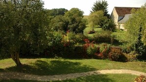 A rural landscape with a grassy area, trees, and a stone building with a sloped roof. - Spacious Historic Presbytery, Sleeps 15, Garden, WiFi, Near Châteaux & La Roche-Posay (Bossay-sur-Claise)
