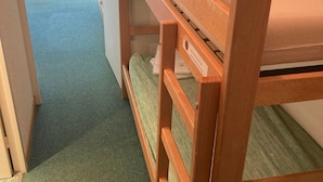 A bunk bed with a wooden frame and a mattress.
