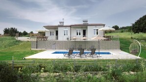 A two-story house with a swimming pool, outdoor seating, and a fenced garden area. - Deatached apartment with shared pool in Tersanas Chania 2 minutes from the beach (chania)