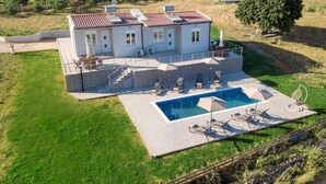 A two-story house with a swimming pool, outdoor seating, and a garden. - Deatached apartment with shared pool in Tersanas Chania 2 minutes from the beach (chania)