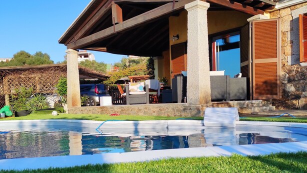 A house with a pool, outdoor furniture, and a stone facade. - Villa Janas with private pool🏖️ (Budoni sardegna)