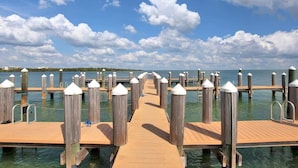 A wooden pier with a clear view of the water and distant shoreline. - Changes in Latitude (MARATHON)