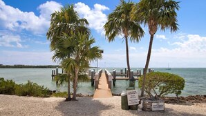 A private property with a dock leading to a pier, a sign prohibiting children, and a clear view of the water. - Changes in Latitude (MARATHON)