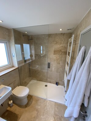 Bathtub, towels, soap, toilet paper