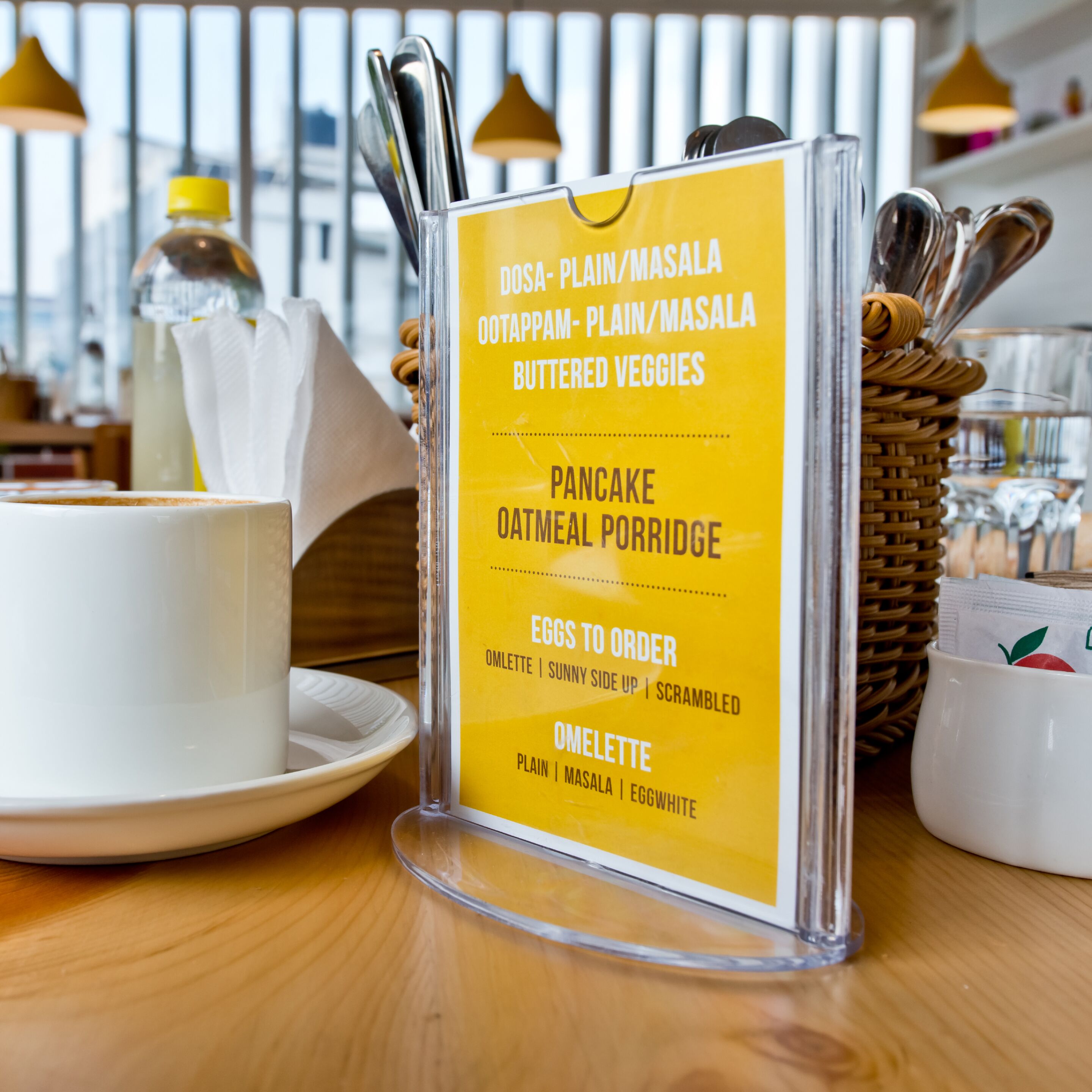 A menu board with breakfast options including pancakes, omelettes, and eggs.