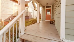 A wooden porch with a bench, a door, and a mailbox. - East Nash 3BR Fenced Yard | Deck | Parking | Pets (Nashville)
