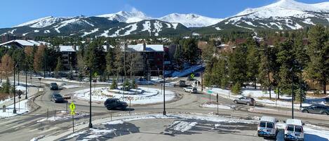 A roundabout with a snow-covered mountain in the background.