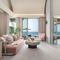 Relax in this elegantly furnished living area with a comfortable sofa, coffee table, and ocean view.