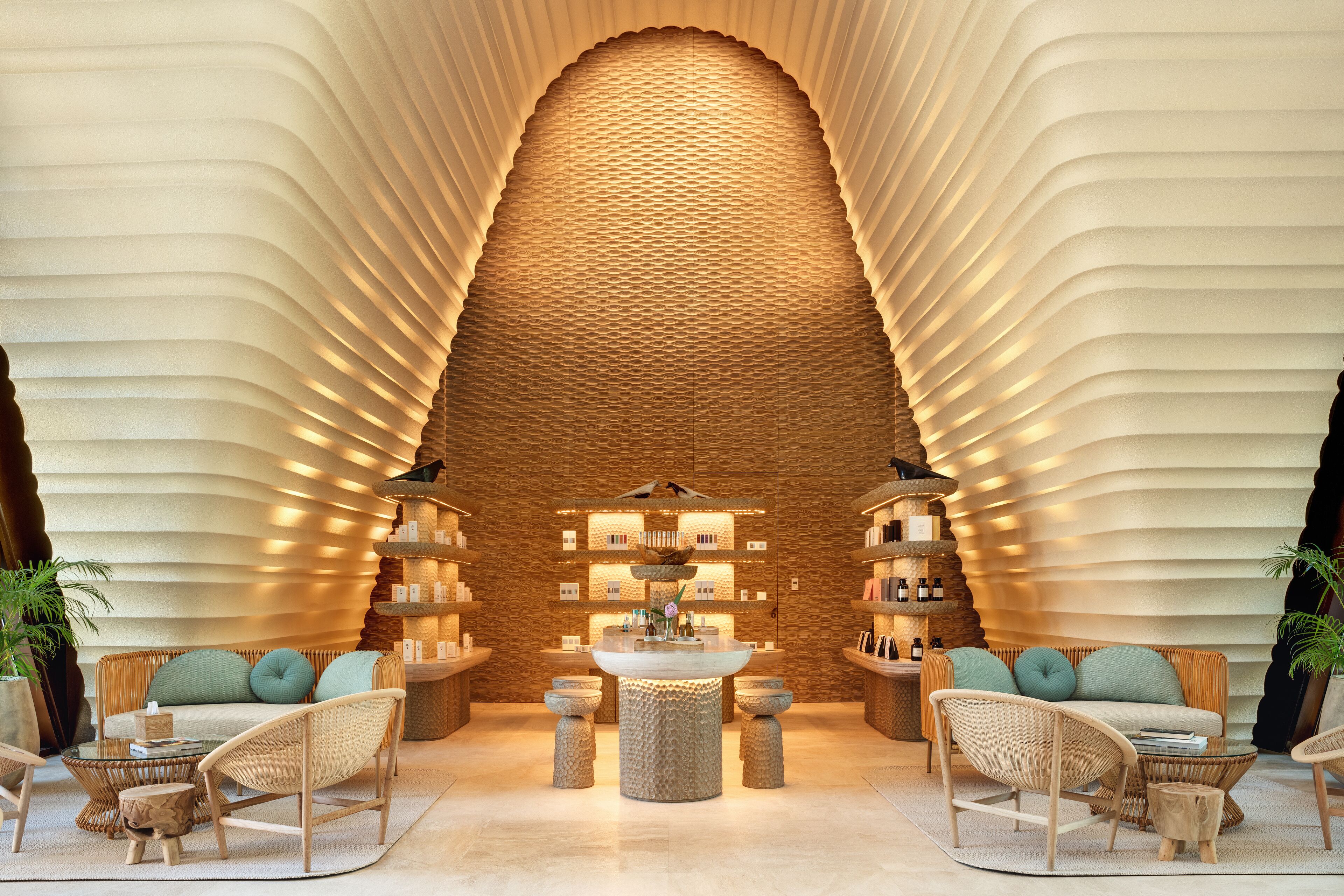 A modern lobby with a central seating area, a textured wall, and a variety of amenities.
