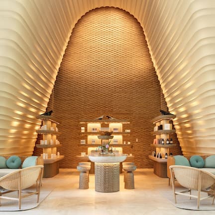 A modern lobby with a central seating area, a textured wall, and a variety of amenities.