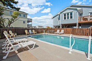 A swimming pool with lounge chairs and a wooden deck. - C And Sky: Ocean Views | Private Pool | Hot Tub (Duck)
