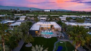 A resort with a swimming pool, multiple guest rooms, and a golf course.