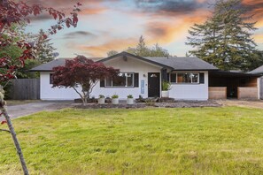 A single-story house with a front yard, a small tree, and a satellite dish. - Year Round Fun - Dog Friendly! (Florence)