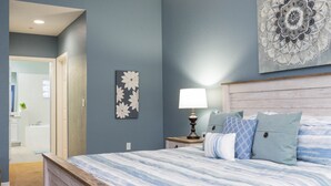A bedroom with a bed, nightstands, a lamp, and a wall art piece. - 9.1 miles from Disney World, Sleeps 8-10, heated pool, hot tub, private balcony (Kissimmee)