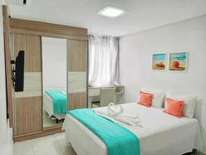 Relax in comfort with a large bed, a wardrobe, and a chair.