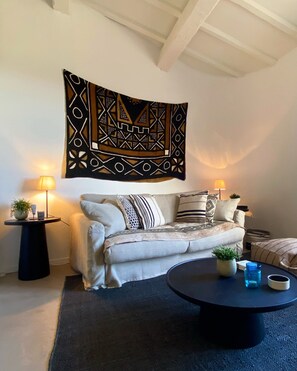 Relax in a stylish living space with a comfortable sofa, coffee table, and floor lamps.