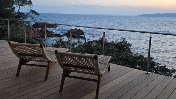 A wooden deck with two wicker chairs facing a coastal view. - Authentic waterfront villa (1st line) with private beach access (Saint Raphael)