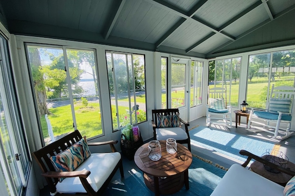 Enclosed front porch perfect for morning coffee and sunrises