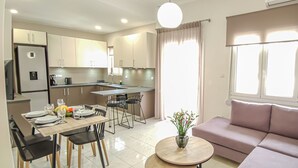 A modern apartment with a dining area, kitchen, and living room. - Fully renovated apartment in the city centre of Chania with a roof garden! (Χανιά)