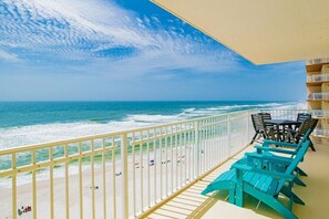 A balcony with a view of the beach and ocean. - Crystal Shores 907 | Beautiful updates, corner unit, beach front! (Gulf Shores)