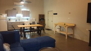 A compact living space with a kitchenette, a dining area, and a seating area.